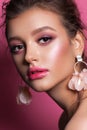 Fashion portrait of a beautiful girl with trendy pink makeup, accessories and background. Brunette model with hazel eyes Royalty Free Stock Photo