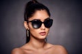 fashion portrait of beautiful Indian woman who wearing sunglasses and golden earrings. Asian glamour Royalty Free Stock Photo