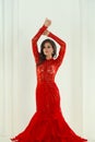 Fashion portrait of beautiful magnificent brunette fashion model woman in red evening gown posing on white background Royalty Free Stock Photo