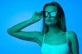 Fashion portrait of beautiful woman face with sunglasses on blue light color Royalty Free Stock Photo