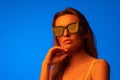 Fashion portrait of beautiful woman face with sunglasses on blue light color Royalty Free Stock Photo