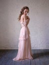 Fashion portrait of beautiful woman in a long pink dress. Royalty Free Stock Photo