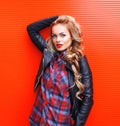 Fashion portrait beautiful young blonde woman with red lips wearing a black rock style over colorful Royalty Free Stock Photo