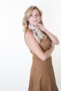Fashion portrait of beautiful young woman with blond hair. Girl in brown dress on white Royalty Free Stock Photo