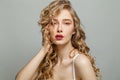 Fashion portrait of beautiful young woman with long blonde curly hair and makeup on white background Royalty Free Stock Photo