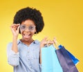 Fashion, portrait and black woman with shopping bags, smile and excited for sale in studio on yellow background. Face Royalty Free Stock Photo