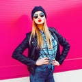 Fashion portrait blonde cool girl sending sweet air kiss posing in rock black style jacket, hat posing on city street Royalty Free Stock Photo