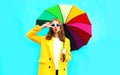 Fashion portrait cool girl sends air kiss with colorful umbrella Royalty Free Stock Photo