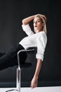 Fashion portrait of daring trendy woman posing on black studio background