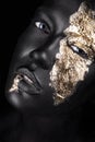 Fashion portrait of a dark-skinned girl with gold Royalty Free Stock Photo