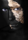 Fashion portrait of a dark-skinned girl with gold make-up. Beauty face. Royalty Free Stock Photo
