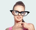 Fashion portrait of funny woman in big glasses, pointing her fin