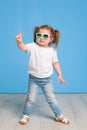 Fashion portrait of girl child on a blue background Royalty Free Stock Photo