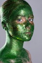 Fashion portrait of girl in green vests, unusual makeup, a fabulous imag