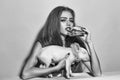 Fashion portrait of a girl with a pig. Girl eating burger with pig Royalty Free Stock Photo