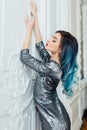 Fashion portrait of gorgeous girl with blue dyed hair long. The beautiful evening cocktail dress. Royalty Free Stock Photo