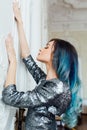 Fashion portrait of gorgeous girl with blue dyed hair long. The beautiful evening cocktail dress. Royalty Free Stock Photo