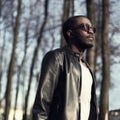 Fashion portrait of handsome african man in black leather jacket Royalty Free Stock Photo