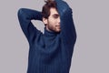 Handsome elegant man with curly hair in blue sweater