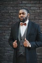 Fashion portrait of a handsome young African American business man walking outdoors in a casual pose Royalty Free Stock Photo