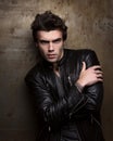 Fashion portrait of handsome young man in a black leather jacket