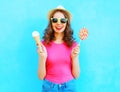 Fashion portrait happy smiling young woman with ice cream and lollipop over colorful blue Royalty Free Stock Photo