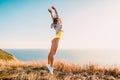 Fashion portrait of jumping happy woman in nature. Sporty woman outdoor Royalty Free Stock Photo
