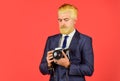 Fashion portrait of man. confident businessman hold retro camera. mature man dyed beard and hair. professional