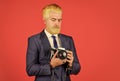 Fashion portrait of man. confident businessman hold retro camera. mature man dyed beard and hair. professional