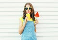 Fashion portrait pretty cool girl drinks a juice from cup holds slice watermelon ice cream