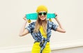 Fashion portrait pretty cool smiling girl with skateboard over white Royalty Free Stock Photo