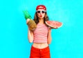 Fashion portrait pretty woman is holding a pineapple and a slice of watermelon Royalty Free Stock Photo