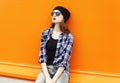 Fashion portrait pretty woman wearing a black hat, sunglasses and shirt over colorful Royalty Free Stock Photo