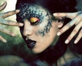 Fashion portrait of pretty young woman with creative make up like a snake, halloween concept Royalty Free Stock Photo