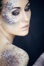 Fashion portrait of pretty young woman with creative make up like a snake Royalty Free Stock Photo