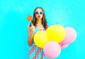 Fashion portrait pretty young woman with yellow an air balloons Royalty Free Stock Photo