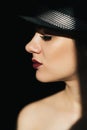 fashion portrait in profile of a young sexy girl in a black hat with red lipstick Royalty Free Stock Photo