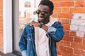 Fashion portrait smiling african man with smart watch using voice command Royalty Free Stock Photo