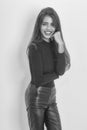 Fashion portrait of a smiling girl. Happy pretty girl in black sweater and leather pants Royalty Free Stock Photo