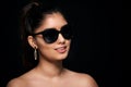 fashion portrait of smiling Indian woman who wearing sunglasses and golden earrings. Asian glamour Royalty Free Stock Photo