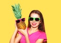 Fashion portrait smiling woman with pineapple in sunglasses over colorful yellow Royalty Free Stock Photo