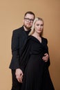 Fashion portrait of a stylish couple in love in black clothes. A man and a woman embrace Royalty Free Stock Photo