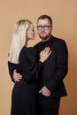 Fashion portrait of a stylish couple in love in black clothes. A man and a woman embrace Royalty Free Stock Photo