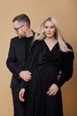 Fashion portrait of a stylish couple in love in black clothes. A man and a woman embrace Royalty Free Stock Photo