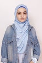 Fashion portrait of stylish muslim girl in jean jacket. Modern and young middle-eastern girl wearing hijab with denim jacket.
