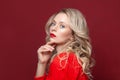 Fashion portrait of stylish woman with perfect makeup. Beautiful model woman with curly hairstyle. Care and beauty, lady in red Royalty Free Stock Photo