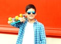 Fashion portrait teenager boy holds a skateboard in sunglasses Royalty Free Stock Photo