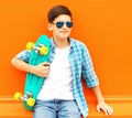 Fashion portrait teenager boy with skateboard wearing a sunglasses Royalty Free Stock Photo