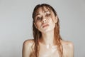 Fashion portrait of a topless young woman with wet hair