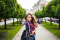 Fashion portrait trendy young woman with backpack in the city simmer